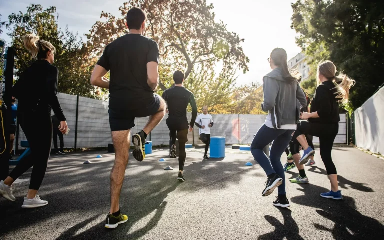 man in black t-shirt and black shorts running on road during daytime