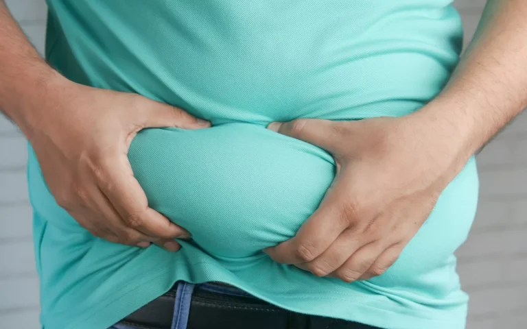 a man holding his stomach with his hands