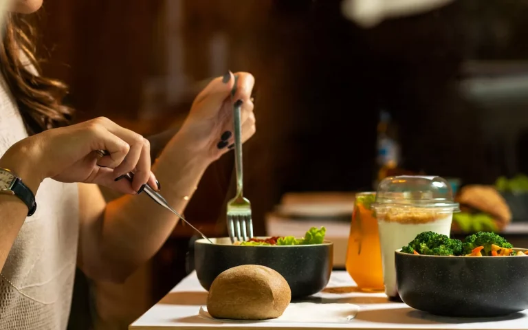 person holding silver fork and knife